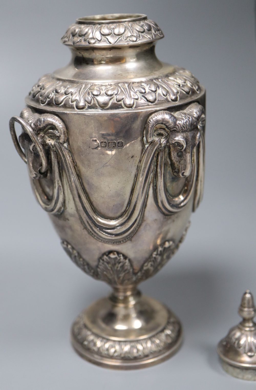 A George V silver vase and cover, with rams head and swag decoration and two ring handles, William Hutton & Sons, Sheffield, 1910,